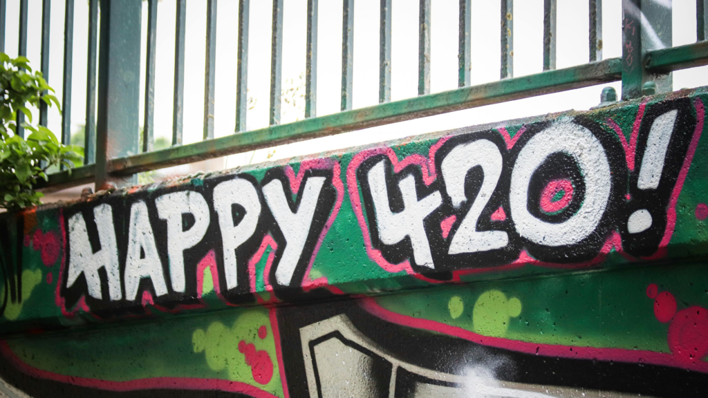 Wall with Happy 420 spray-painted on it.