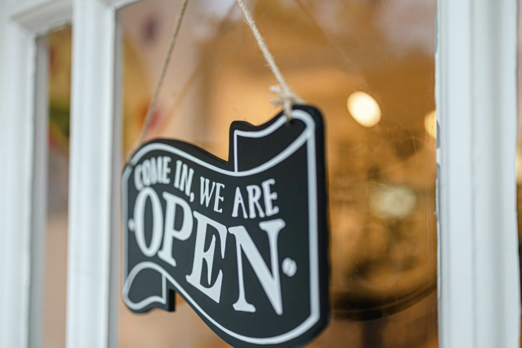 Come in, we're open sign on glass window